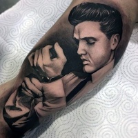 Very realistic looking memorial black ink Elvis portrait tattoo on arm