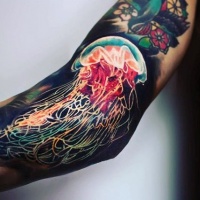 Very realistic looking multicolored jellyfish tattoo on arm
