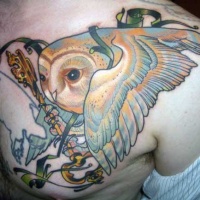 Very realistic looking multicolored owl with antic key tattoo on chest