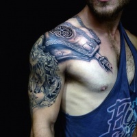 Very realistic looking old medieval armor like tattoo on shoulder