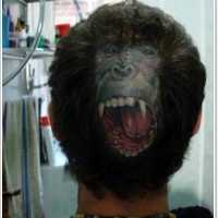 Very realistic looking original placed roaring monkey face tattoo on head