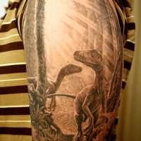 Very realistic looking painted black and white dinosaurs in forest half sleeve tattoo