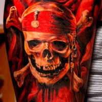 Very realistic massive colored pirate emblem skull tattoo on arm