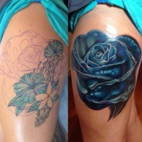 Very realistic painted massive blue rose tattoo on thigh