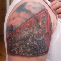 Vintage art style colored upper arm tattoo of steam train near old factory
