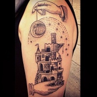 Vintage black ink fantasy castle tattoo on shoulder stylized with moon and stars
