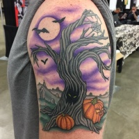 Vintage cartoon like colored creepy tree tattoo on shoulder with moon and bats