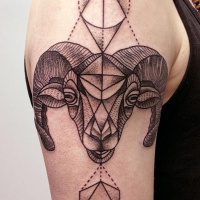 Vintage like black ink big goat head tattoo on shoulder stylized with geometric figures