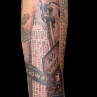 Vintage photo like colored forearm tattoo of American city sights