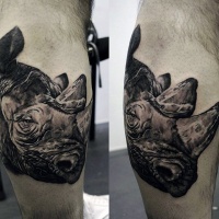 Vintage photo style black and white leg tattoo of big rhino head
