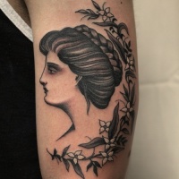 Vintage picture style colored shoulder tattoo of woman portrait with flowers