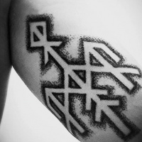 Vintage stippling style arm tattoo of ancient tribal symbol