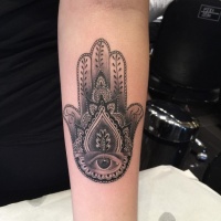 Vintage style black and white mystical Hamsa hand tattoo on forearm zone