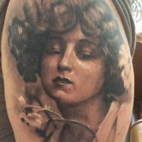 Vintage style black and white shoulder tattoo of woman portrait with flower