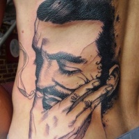 Vintage style black ink back tattoo of smoking man face