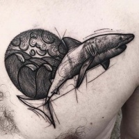 Vintage style black ink colored shark tattoo on chest combined with circle shaped waves