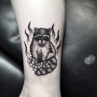 Vintage style black ink funny raccoon tattoo on ankle with flowers