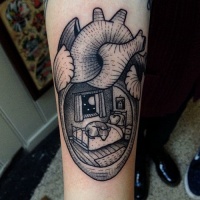 Vintage style black ink heart shaped tattoo on forearm stylized with sleeping fox in house