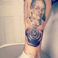Vintage style black ink leg tattoo of old woman portrait with rose