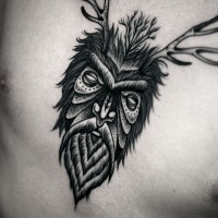 Vintage style black ink mystical man portrait tattoo on chest stylized with deer horns