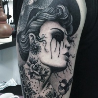 Vintage style black ink shoulder tattoo of crying woman with big hat and flowers