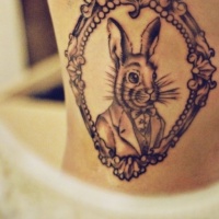 Vintage style black ink side tattoo of rabbit portrait