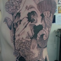Vintage style black ink side tattoo of woman with flowers and goat skull