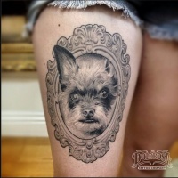 Vintage style black ink thigh tattoo of cute dog portrait