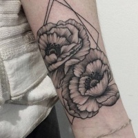 Vintage style black ink wild flowers tattoo on forearm combined with geometrical figures