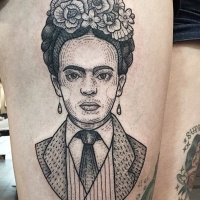 Vintage style black ink woman portrait tattoo on thigh with flowers