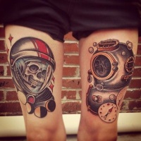 Vintage style colored thigh tattoo of old astronaut and diver suits