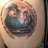 Vintage style detailed thigh tattoo of Charlie Chaplin with lettering