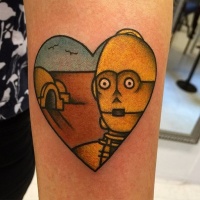 Vintage style heart shaped colored tattoo on forearm stylized with C3PO