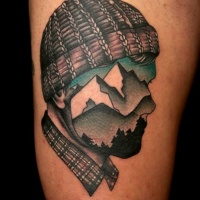 Vintage style painted and colored half portrait half mountains picture tattoo on thigh