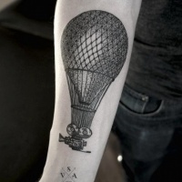 Vintage style painted big balloon with camera tattoo on arm