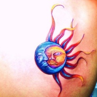 Vivid colors moon and sun tattoo on shoulder blade