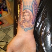 Watercolor angel girl tattoo on wrist