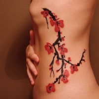 Watercolor cherry blossom tattoo in japanese style on ribs