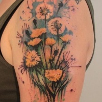 Watercolor dandelions flowers tattoo on arm