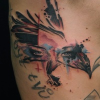 Watercolor face of woman and bird tattoo on ribs
