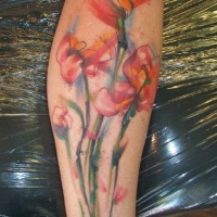 Watercolor flowers tattoo on leg