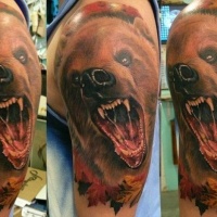 Watercolor head of a bear with open mouth tattoo on shoulder