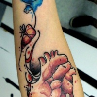 Watercolor heart and a balloon forearm tattoo