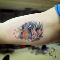 Watercolor hedgehog tattoo on arm
