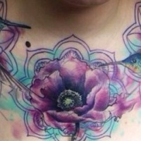 Watercolor hummingbird hovering near a flower tattoo on chest
