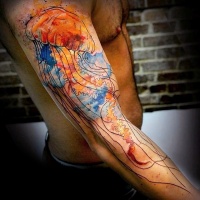 Watercolor like big jellyfish tattoo on arm