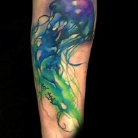 Watercolor like painted colorful jellyfish tattoo on arm