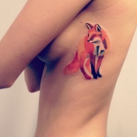 Watercolor red fox tattoo on ribs