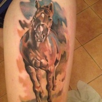 Watercolor running horse tattoo on thigh