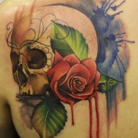 Watercolor skull and red rose tattoo on shoulder blade